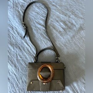 LIKE DREAMS Agatha mini vegan satchel. Large Tortoise‎ Ring Studded Front Detail